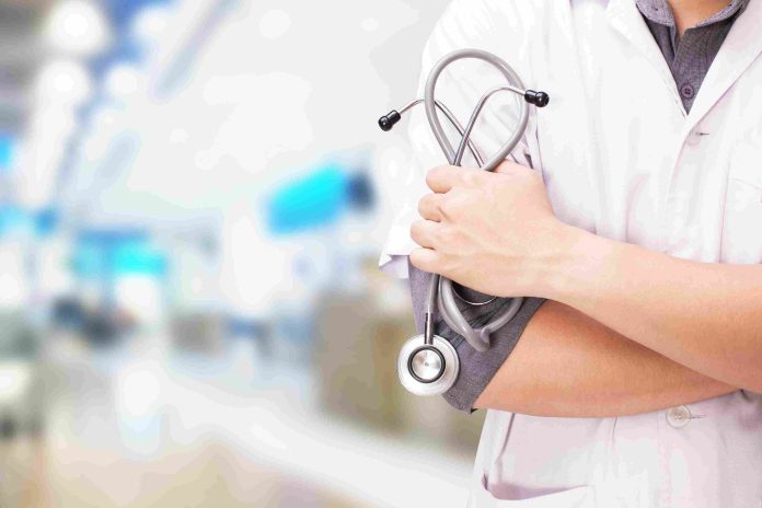 medical billing and coding doctor with stethoscope hands hospital background